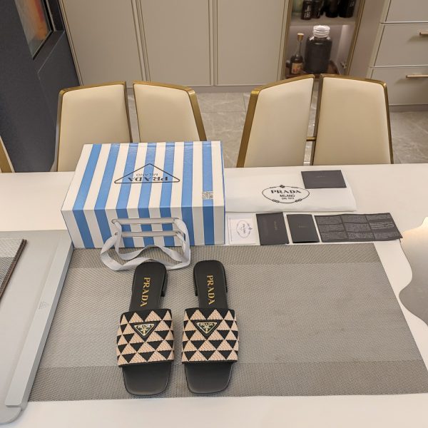 The Prada woven stretch upper is embellished with a two-tone metal buckle with the iconic logo